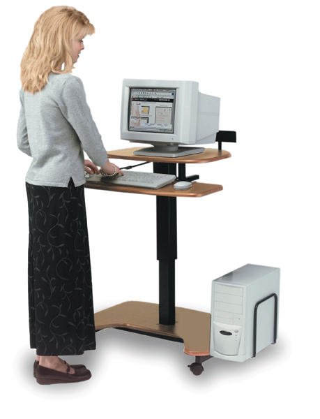 Picture of a woman standing at the computer to help treat low back pain