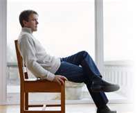 Picture of a man sitting causing low back pain